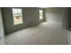 Bedroom with neutral colored walls, two windows for natural light, and white trim at 202 Tuskeegee Dr, Smithfield, NC 27577