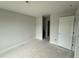 Bedroom with neutral colors, door for entry and closet, and natural light at 202 Tuskeegee Dr, Smithfield, NC 27577