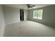 Spacious bedroom with a ceiling fan and a window overlooking the lush greenery outside at 202 Tuskeegee Dr, Smithfield, NC 27577