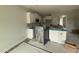New eat-in kitchen with white cabinets and stainless appliances; under construction at 202 Tuskeegee Dr, Smithfield, NC 27577