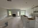 Unfinished kitchen and living area featuring a fireplace, an island, and white cabinets at 202 Tuskeegee Dr, Smithfield, NC 27577
