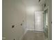 Unfinished laundry room with utility hookups and a white door to another room at 202 Tuskeegee Dr, Smithfield, NC 27577