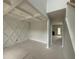 Unfinished living room with decorative wall trim, coffered ceilings, and view to the foyer and fireplace at 202 Tuskeegee Dr, Smithfield, NC 27577