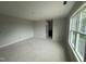 Living room area with neutral colored walls, large window with natural light, and open design at 202 Tuskeegee Dr, Smithfield, NC 27577