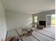 Bright living room with fireplace and glass door to patio at 202 Tuskeegee Dr, Smithfield, NC 27577