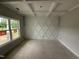 Unfinished living room featuring decorative wall trim, coffered ceilings, and a large window with a view at 202 Tuskeegee Dr, Smithfield, NC 27577
