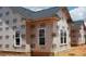 Exterior home under construction showing wood framing and white framed windows awaiting brick or siding at 219 Crescent Dr, Dunn, NC 28334
