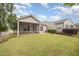 Grassy backyard features a screened porch and is framed by mature trees and shrubs at 219 Rosedale Creek Dr, Durham, NC 27703
