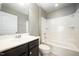 Well lit bathroom featuring a tub with shower, single sink vanity, and tile flooring at 219 Rosedale Creek Dr, Durham, NC 27703