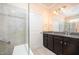Bathroom featuring double sink vanity, glass-enclosed shower, and granite countertops at 219 Rosedale Creek Dr, Durham, NC 27703