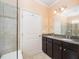 Bathroom featuring double sink vanity, glass-enclosed shower, and granite countertops at 219 Rosedale Creek Dr, Durham, NC 27703