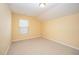 Bedroom with beige walls and carpet plus a large window allowing for plenty of natural light at 219 Rosedale Creek Dr, Durham, NC 27703
