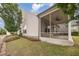 Back exterior view of house showing a screened in porch and healthy green yard at 219 Rosedale Creek Dr, Durham, NC 27703