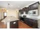 Well-equipped kitchen featuring granite countertops, stainless steel appliances and dark wood cabinetry at 219 Rosedale Creek Dr, Durham, NC 27703