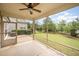 Relaxing screened porch with ceiling fan, beautiful lawn, and backyard view at 219 Rosedale Creek Dr, Durham, NC 27703