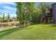Backyard view of a tree-lined lawn leading to a serene pond at 2212 Plowridge Rd, Fuquay Varina, NC 27526