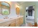 Charming bathroom with dual vanities, decorative wallpaper, and a view into the serene bedroom space at 2212 Plowridge Rd, Fuquay Varina, NC 27526