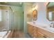 Stylish bathroom showcasing a glass-enclosed shower, soaking tub, and double vanity with ample counter space at 2212 Plowridge Rd, Fuquay Varina, NC 27526