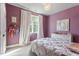 Inviting bedroom features ample natural light, light carpet, and a decorative chandelier at 2212 Plowridge Rd, Fuquay Varina, NC 27526