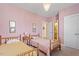 Charming bedroom with two twin beds, classic decor, and soft pink walls at 2212 Plowridge Rd, Fuquay Varina, NC 27526