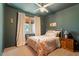 Cozy bedroom features warm wall color, white metal frame bed, and bright natural light at 2212 Plowridge Rd, Fuquay Varina, NC 27526