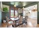Elegant dining room with hardwood floors, wainscoting, stylish lighting, and access to outdoor at 2212 Plowridge Rd, Fuquay Varina, NC 27526