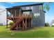 Home exterior featuring a screened porch, wooden deck, and a spacious backyard with healthy green grass at 2212 Plowridge Rd, Fuquay Varina, NC 27526
