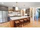 Spacious kitchen featuring a large center island, stainless steel appliances, and custom cabinetry at 2212 Plowridge Rd, Fuquay Varina, NC 27526