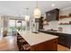 Spacious kitchen island features counter seating and a dining area with pendant lights and stainless steel appliances at 2212 Plowridge Rd, Fuquay Varina, NC 27526