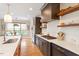Modern kitchen boasts stainless appliances, dark cabinetry, and bright quartz countertops with eat in kitchen area at 2212 Plowridge Rd, Fuquay Varina, NC 27526