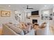 Comfortable living room featuring a fireplace, built-in shelving, and hardwood floors at 2212 Plowridge Rd, Fuquay Varina, NC 27526