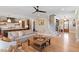Open living room with hardwood floors, a fireplace, and access to the kitchen at 2212 Plowridge Rd, Fuquay Varina, NC 27526