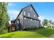 The rear exterior features dark siding, lots of windows, and a covered back porch at 2212 Plowridge Rd, Fuquay Varina, NC 27526