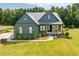 Beautiful two-story home with a manicured lawn and inviting front porch at 223 Lindo Johnson Rd, Pittsboro, NC 27312