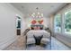 Serene main bedroom with a chandelier, two chairs, and an ensuite bathroom at 223 Lindo Johnson Rd, Pittsboro, NC 27312