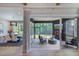 Cozy outdoor living space with a fireplace, dining area, and screened in patio at 223 Lindo Johnson Rd, Pittsboro, NC 27312