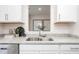 Modern kitchen sink boasts granite countertop and stylish decor against white cabinetry at 228 Moyer Dr, Graham, NC 27253
