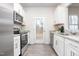 Bright kitchen features stainless appliances, white cabinets, and a granite countertop at 228 Moyer Dr, Graham, NC 27253