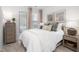 Neutral bedroom with natural light, stylish furnishings, and a full length mirror at 232 Moyer Dr, Graham, NC 27253