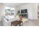 Bright living room featuring a large window, comfortable couch, and entertainment center at 232 Moyer Dr, Graham, NC 27253
