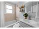 Charming bathroom with a shower-tub combination, tiled walls, and ample natural light at 2331 Bernard St, Raleigh, NC 27608