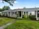 Exterior view of the townhouse with well-maintained lawn, stone walkway and traditional shutters at 2331 Bernard St, Raleigh, NC 27608