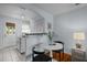Eat-in kitchen featuring a white table set with chairs, pass-through, and bright white walls at 2331 Bernard St, Raleigh, NC 27608