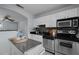 Bright kitchen with stainless appliances, white cabinets, dark countertops, and decorative serving bar at 2331 Bernard St, Raleigh, NC 27608