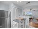 Bright kitchen with stainless appliances, white cabinets, decorative serving bar and tile floors at 2331 Bernard St, Raleigh, NC 27608