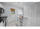 Bright kitchen with white cabinetry, neutral tile floors, rolling island and backdoor at 2331 Bernard St, Raleigh, NC 27608