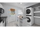 Light and bright kitchen featuring a laundry closet with a stackable washer and dryer set at 2331 Bernard St, Raleigh, NC 27608