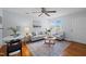 Bright living room featuring a ceiling fan, hardwood floors, modern furniture, and a decorative rug at 2331 Bernard St, Raleigh, NC 27608