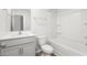 Bright bathroom featuring a shower-tub combo with white tiling and a single-sink vanity at 236 Moyer Dr, Graham, NC 27253