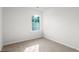Bedroom with neutral carpet, white walls, and a window providing natural light at 236 Moyer Dr, Graham, NC 27253